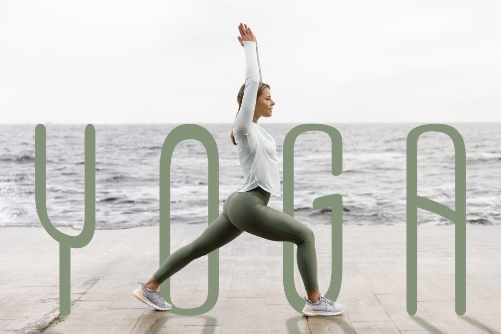 Woman practicing yoga in a lunge pose by the ocean with the word “YOGA” displayed artistically across the image, symbolizing inspiration and mindfulness for yoga quotes and motivation.